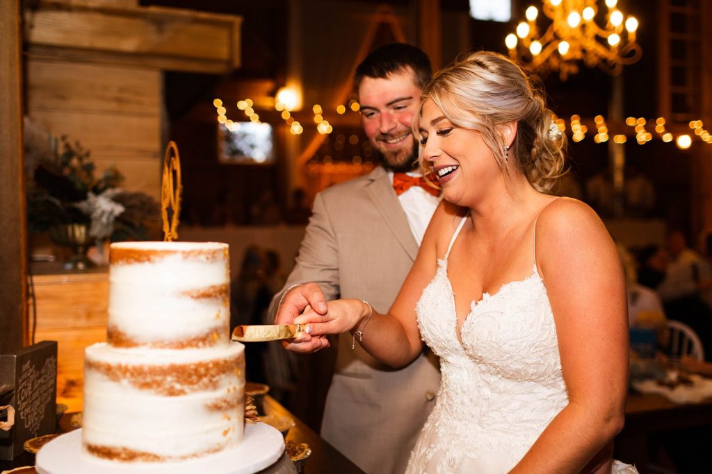 Bride and groom cutting wedding cake