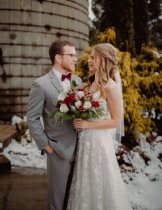 Couple standing near snow at a WI winter wedding