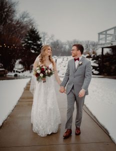 Couple walking near snow during a winter wedding in Wisconsin