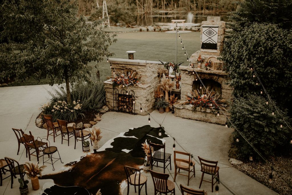 Boho western wedding ceremony with cowhides down the aisle