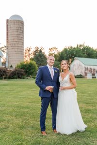 Bride and groom in front of Wisconsin summer wedding venue