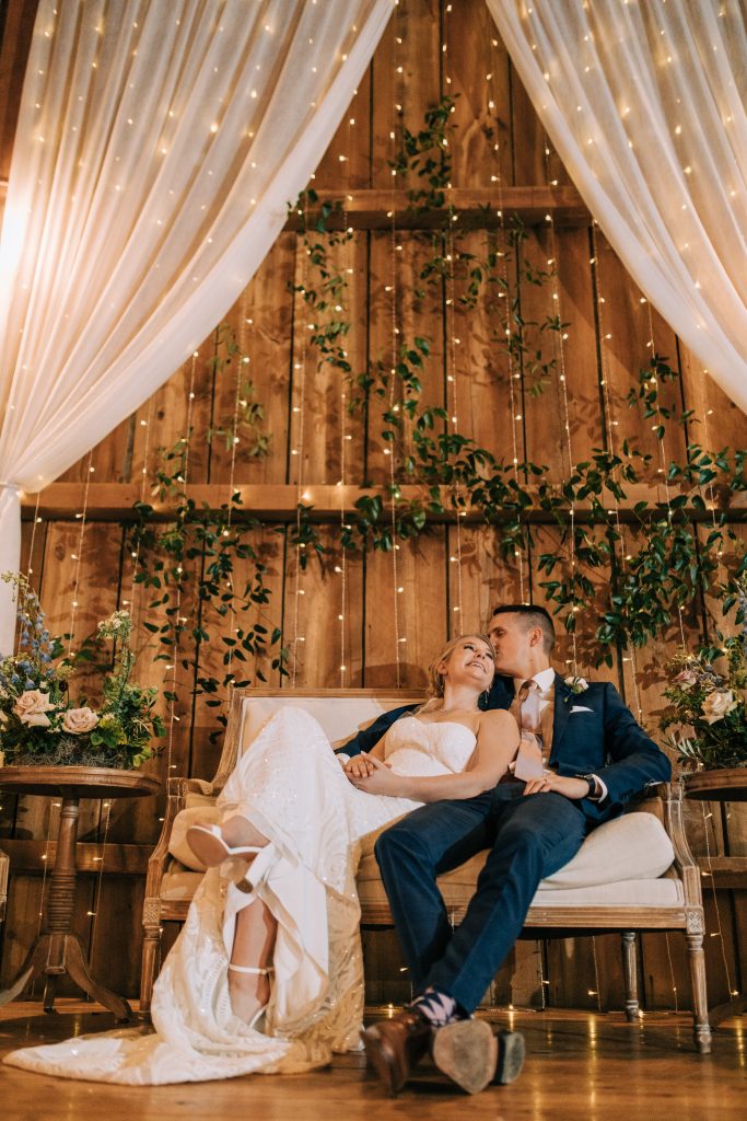 Bride and groom smile at their barn wedding
