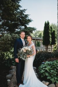 Bride and groom smile during portraits at outdoor wedding in Wisconsin