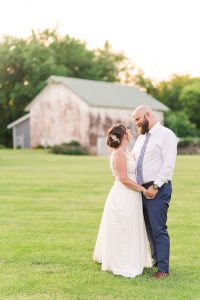 Bride and groom pose for photos at their outdoor wedding venue in Wisconsin