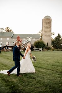 Bride and groom walk on the property at their Wisconsin wedding venue